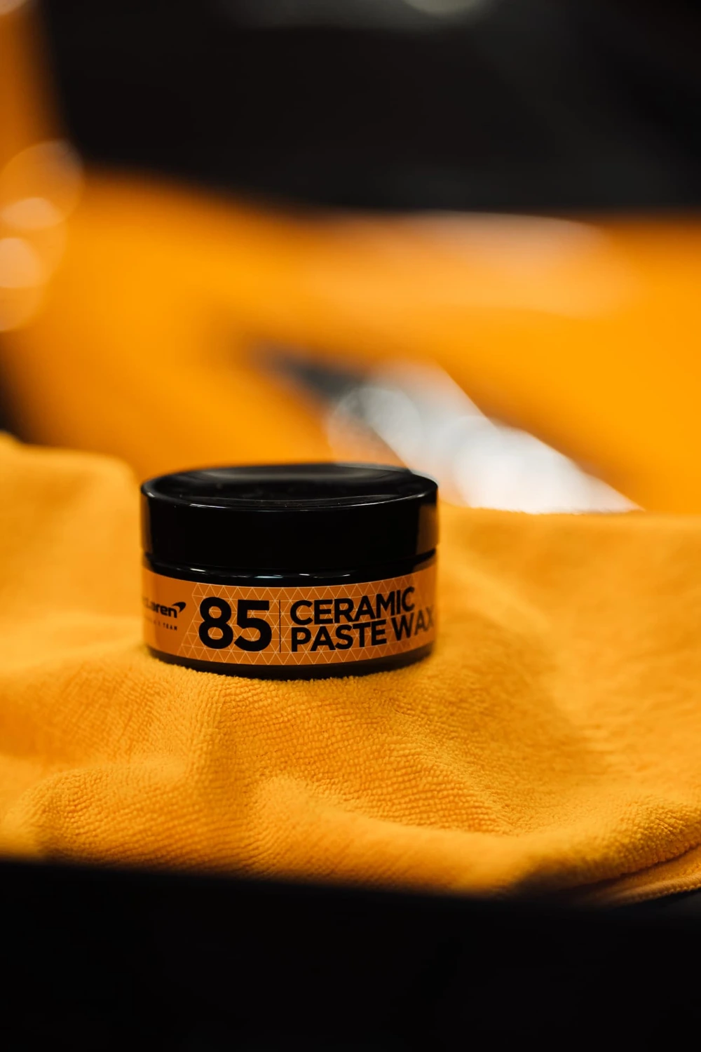 Pot McLaren 85 Ceramic Paste Wax posé sur une microfibre orange